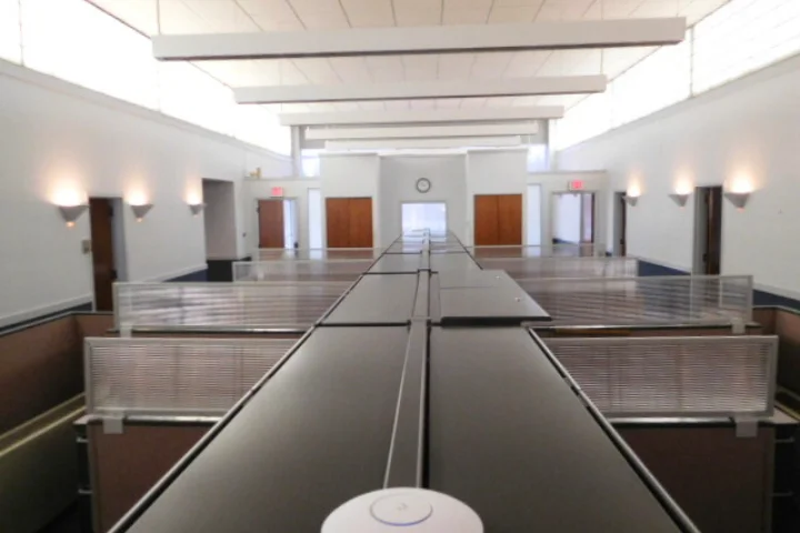 Commercial Building Inspection for Leases in New York, A Inspector in a hard hat and safety vest inspects a door frame while holding a clipboard