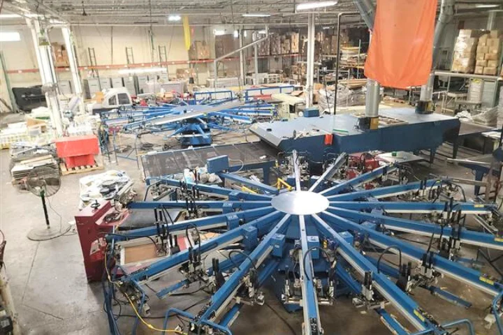Industrial Building Inspections in New York, Two inspector discuss blueprints while looking up at a building structure.
